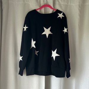 Umgee sweatshirt. Black with white start. New with tags. Runs slightly small.